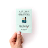 How to Care For Your Introvert Zine featuring a mint green page with cute illustrated figures and text about feeling lucky to have introverts as friends or partners, shown being held by a hand with neutral nail polish