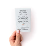 How to Support Someone Zine shown as a light blue card being held, featuring handwritten-style text that reads "Remember: There is no perfect thing to do or say. At the end of the day, just showing up and letting them know they're not alone is the most important thing you can do.
