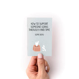 How to Support Someone Zine shown held in hand, featuring a minimalist sage green cover with black text and simple illustrations of a tissue box and flowers. The small booklet is printed on high-quality cardstock and displays compassionate guidance for supporting loved ones.