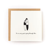 Sorry You're Going Through This Letterpress Card showing two people hugging with sympathy message on white cardstock.
