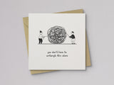 Sympathy card showing two people untangling a large knot with text you don’t have to untangle this alone.