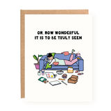 Valentine’s Day card showing a person relaxing on a couch surrounded by snacks and books with heartfelt text above.