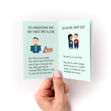 How to Care For Your Introvert Zine shown open to illustrated pages featuring advice about understanding introverts' need for alone time and social preferences, displayed on mint green paper with hand-drawn characters and text, held against a white background.