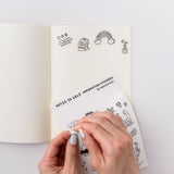 Self Care Sticker Sheet Variety Pack shown in use, with hands placing decorative stickers featuring motivational doodles and affirmations onto a blank journal page. Simple black line illustrations include a backpack, rainbow, and plant designs against a crisp white background.