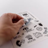 Photo of a hand holding a cute clear sticker.  The sticker has a motivational message that says, Did Nothing.