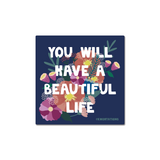 You Will Have a Beautiful Life sticker featuring bold white text on a navy blue background, adorned with delicate floral illustrations in pink, coral, and sage green, creating an uplifting and decorative design by Kwohtations