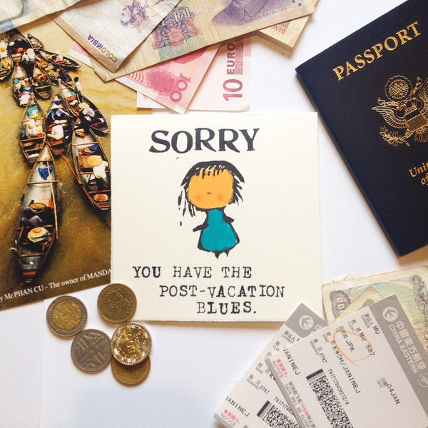 card with animated drawing surrounded by money and passport