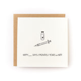 Happy X on HRT! Gender Transition Letterpress Card with syringe and vial illustration on white cardstock.