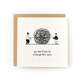 Sympathy card showing two people untangling a large chaotic ball of string with supportive message below