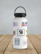 White water bottle with black lid and handle, decorated with various colorful and black-and-white motivational stickers featuring people, inspirational quotes, and playful designs.