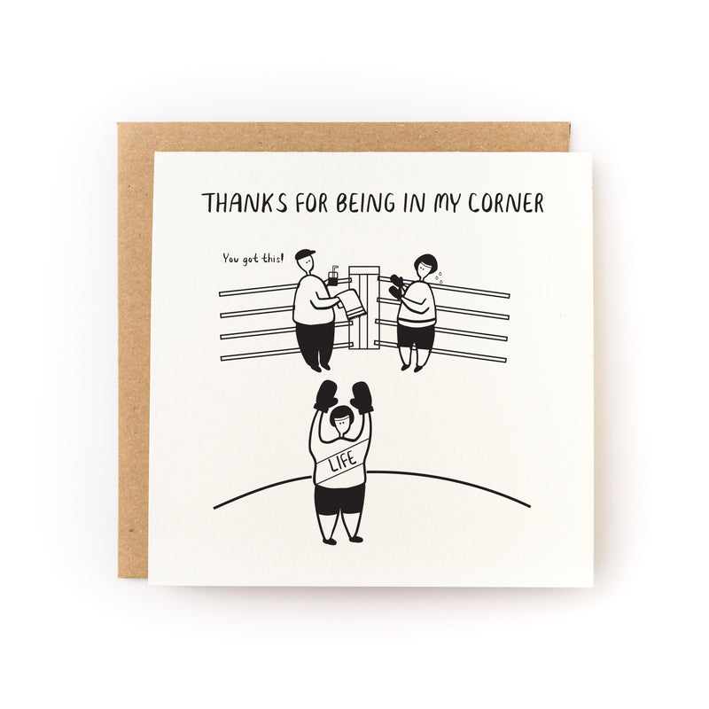 Thanks For Being In My Corner Letterpress Card featuring a minimalist black and white illustration of boxing ring scene with simple line drawings showing three figures, one as a referee and two in the ring corners, printed on white cardstock with kraft envelope