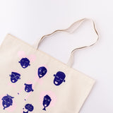 Flat lay of canvas We Give Me Hope screenprinted cotton tote