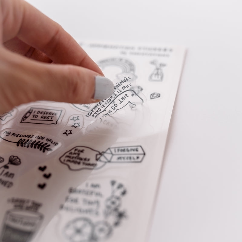 Photo of a hand holding a cute clear sticker.  The sticker has a positive affirmation message that says, I Can Do This.