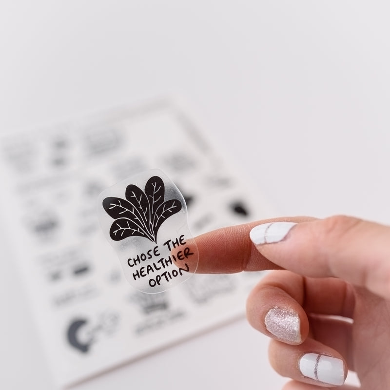 Photo of a hand holding a cute clear sticker.  The sticker has a motivational message that says, Chose the Healthier Option.