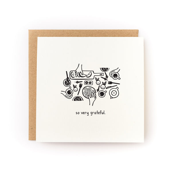 Thank you card that reads "so very grateful" with an illustration of hands grabbing different foods. White card is paired with a kraft envelope.
