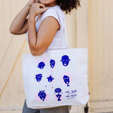Woman holding We Give Me Hope cotton tote bag