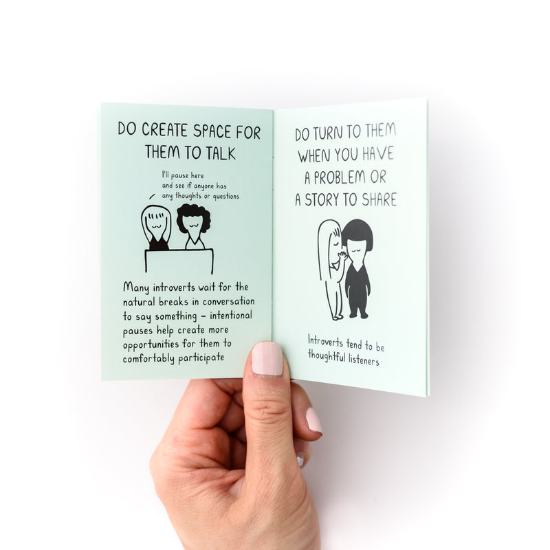 Hand holding open small mint book with illustrations of a 2 people and says "Do create space for them to talk, do turn to them when you have a problem or a story to share"